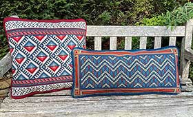 Chevron Long Lumbar 06 with Anatolia 08 companion pillow in reds, and blues from the Cross-Point™ Collection