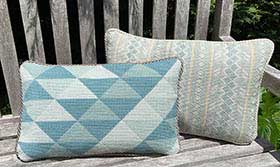 two geometric cushions in seafoam and sages